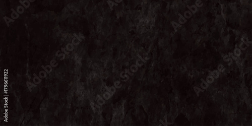 A dark textured background featuring a dense almost entirely black fuzzy or fibrous material surface