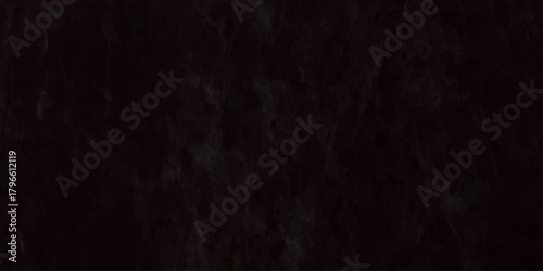 A dark textured background displaying a close up view of what appears to be a black fibrous material or substance