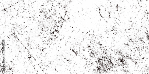Rough grainy grunge texture featuring distressed speckles and various black particles are surrounding the white background, faded details, and raw vintage surface perfect for edgy design projects.