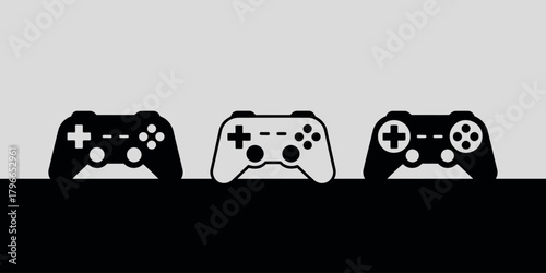 Three video game controllers in a row on a split background