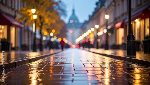 Wallpaper Mural A narrow street glows with golden lights reflected on wet cobblestones, framed by buildings and blurred figures Torontodigital.ca