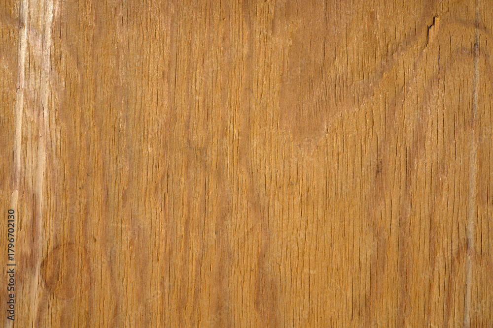 Naklejka premium The background is a light colored wooden texture. Wooden table top view.
