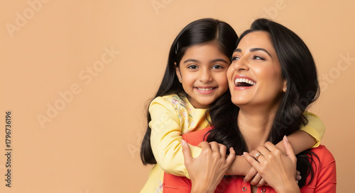 Indian Mother Daughter Hugging Happily on Beige Background