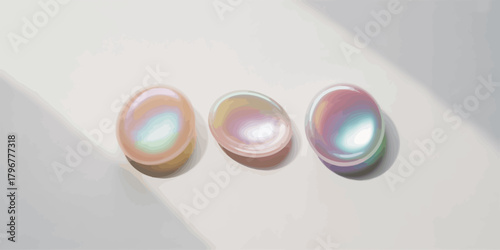 Three iridescent oval stones casting soft shadows on a light background
