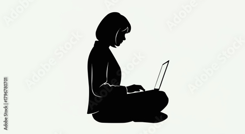 Silhouette of a woman working on a laptop, focused and engaged.