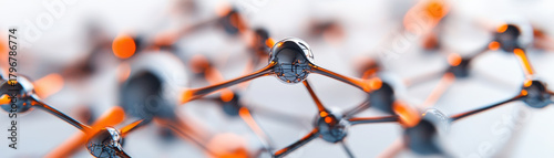 Molecular structure with connected atoms in scientific digital rendering showing detailed bonds and reflective surfaces in orange and black tones