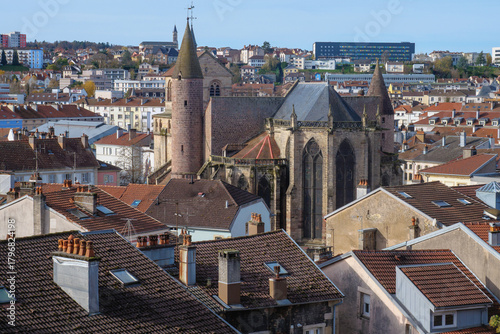 A high-quality cityscape of downtown Épinal, located in the Vosges region of northeastern France. The image showcases the harmonious blend of historic French architecture, modern urban elements