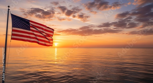 American flag waving over ocean sunset