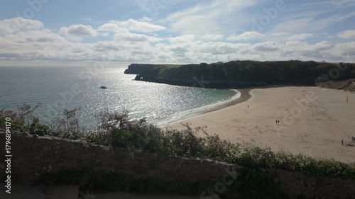 Summertime establishing shot of Barafundle Bay Beach on the Pembrokeshire coast, Wales.