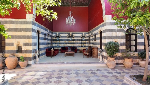 Obraz w ramie A charming view of the Talisman Hotel in Old Damascus, located in the historic Jewish Quarter. The traditional Arabic house features soft pink walls, classic courtyard architecture, and authentic Leva
