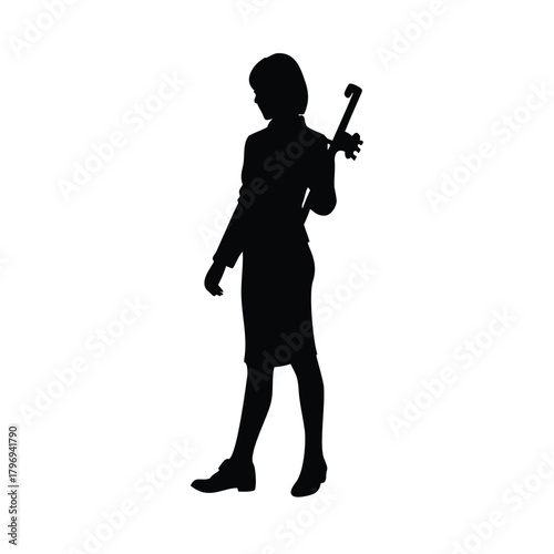 Silhouette of a woman in a suit holding a rifle on her back