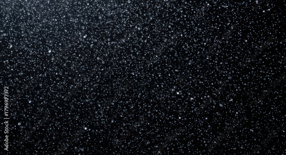 Fototapeta premium A close-up, high-contrast shot of a dark, textured surface with tiny, sparkling particles scattered across it.