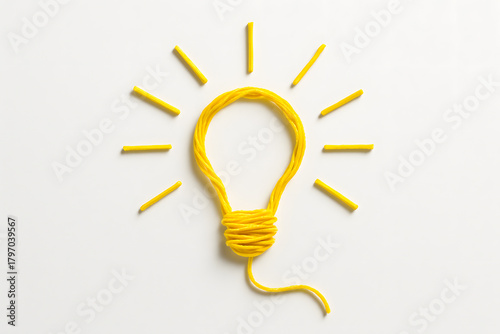 Creative Yarn Idea: A Yellow Lightbulb of Inspiration on White Background