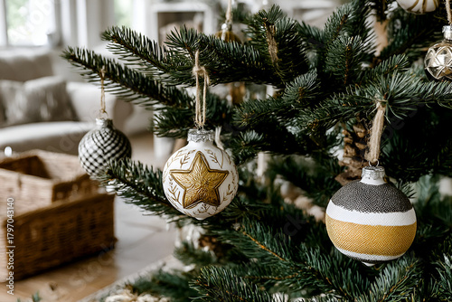 Close up of christmas tree with ornament balls decorations, blurry living room background 