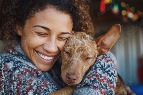 A woman holding a baby goat in her arms