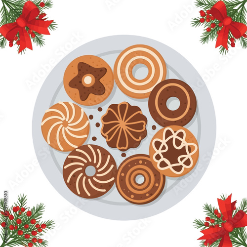 A plate of assorted festive Christmas cookies with red bows and green fir branches in the corners, viewed from above.