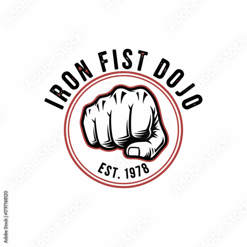 A martial arts style logo featuring a clenched fist within a circle, and surrounding text
