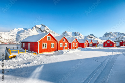 Amazing scenery with traditional Norwegian red wooden houses on the shore of  Sundstraumen strait.