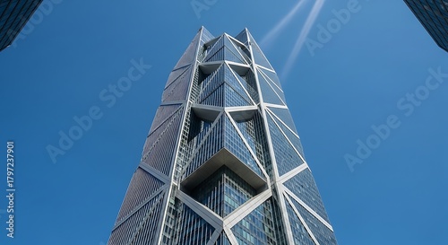 Looking up at the modern architecture of the cctv headquarters building in beijing, china, showcasing its unique design against a clear blue sky