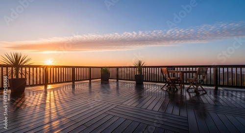 Scenic sunrise view from wooden deck featuring outdoor furniture and potted plants, beautiful morning light.