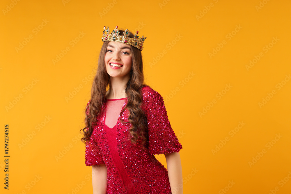 Fototapeta premium Woman wearing luxury crown on orange background