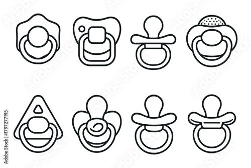 Various pacifier designs on dark striped background