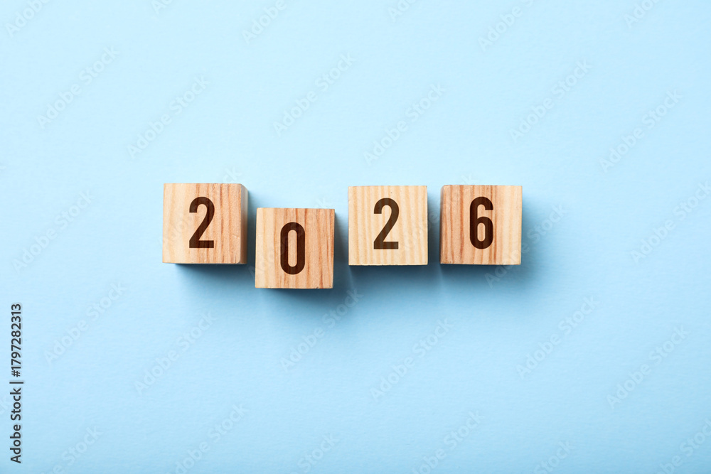 Obraz premium New 2026 year. Cubes with numbers on light blue background, top view
