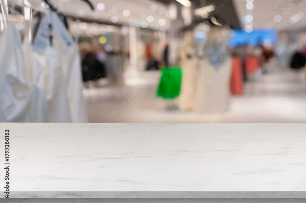Obraz premium Empty white marble table in shop, blurred background. Space for design