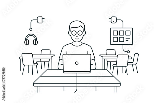 Focused young professional working on a laptop at a desk in a modern co-working space