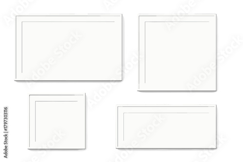 Set of four blank white picture frames in different orientations for a gallery wall display