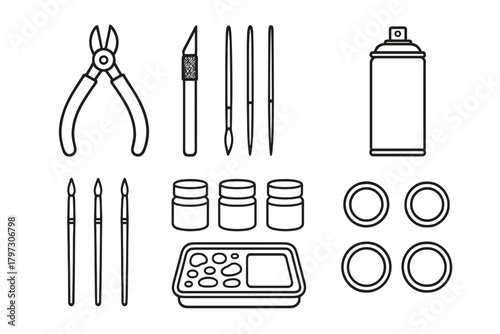 Set of essential hobby modeling tools and supplies including brushes, knife, pliers, and paint