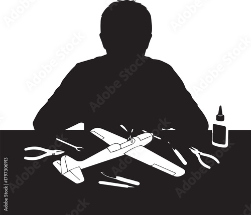 Hobbyist silhouette assembling model airplane with tools and glue focused activity