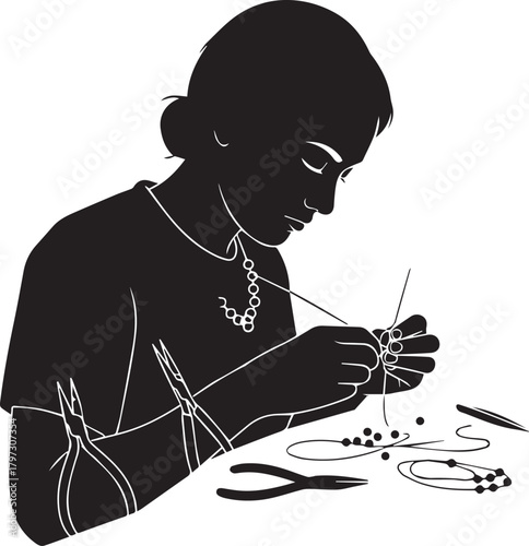 Silhouette of a person intently crafting jewelry with beads and tools artistic hobby creative pursuit