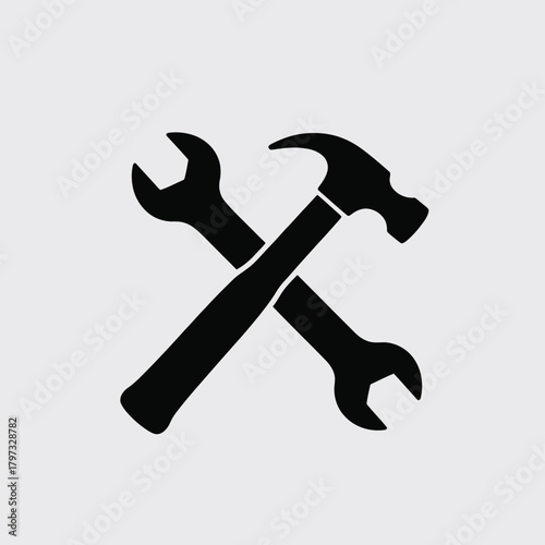 Hammer and wrench crossed black silhouette tool