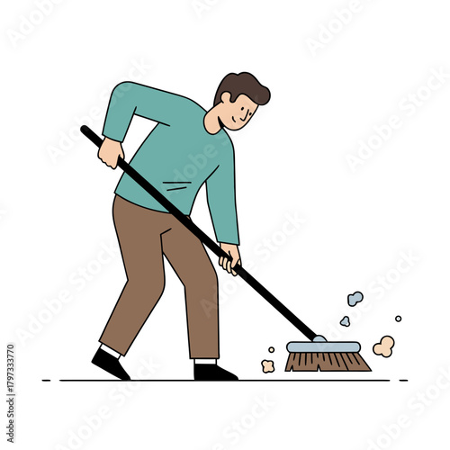 A man in a teal shirt and brown pants sweeping a floor with a broom, creating dust.