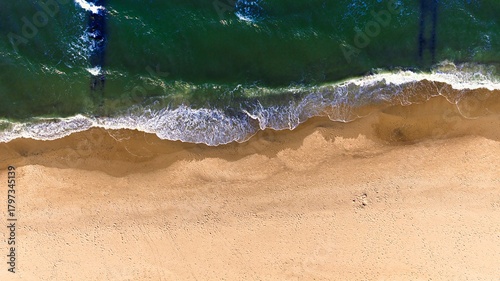 Sparkling sea surface and calm waves near the coast on a bright spring day.