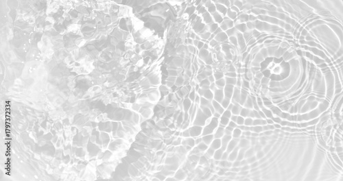 White water with ripples on the surface. Defocus blurred transparent white colored clear calm water surface texture with splashes and bubbles. Water waves with shining pattern texture background.