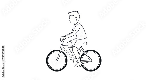 A young boy in a t-shirt and shorts riding a bicycle.