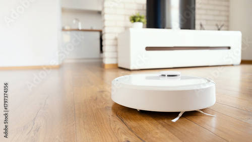 White robot vaccum cleaner in the living room