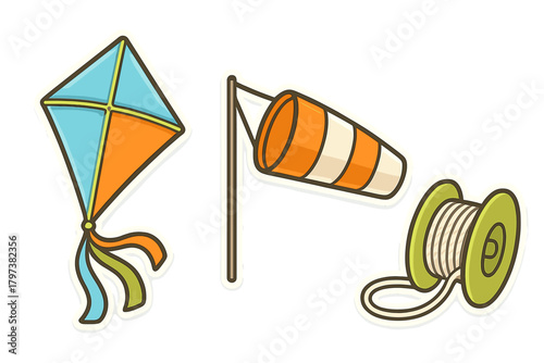 Colorful kite, windsock, and spool of string for outdoor flying activity