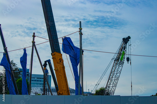 A cityscape of moving crane at the under construction in Tokyo telephoto shot