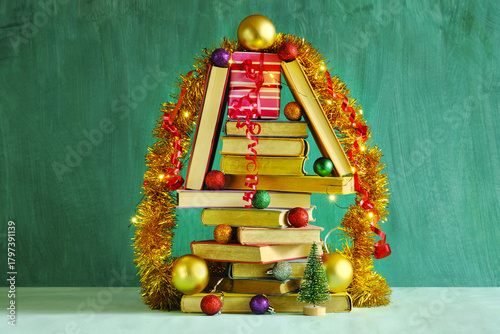 books as christmas gift,christmas present,reading,literature,education, christmas,holiday concept with heap of books, christmas tree and decoration