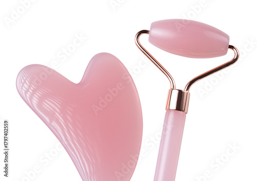 Pink Gua Sha massage tool on a white background, close-up. Rose Quartz jade roller.