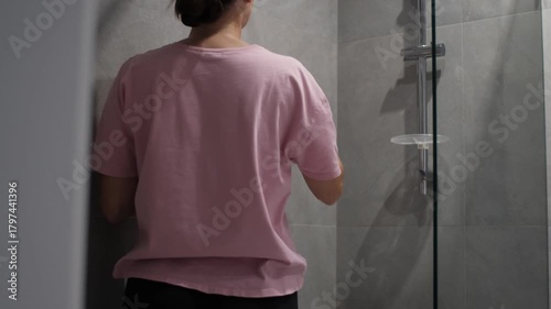 Shower glass scrubbing in home bathroom