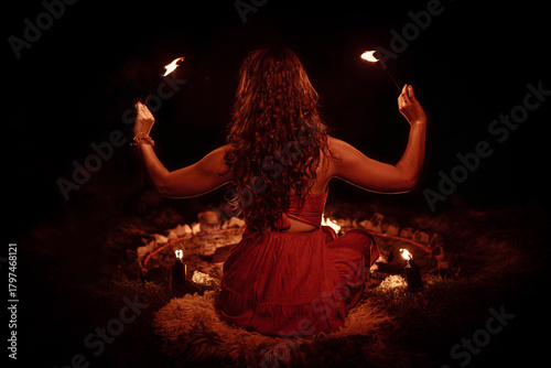 An enchanting fire dancer beautifully showcases her talent with mesmerizing flames during a performance.