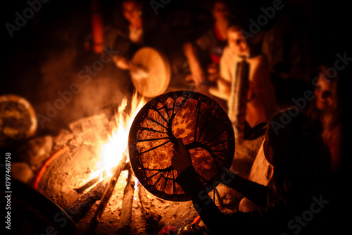 Night fire ceremony. Women play shaman drums.