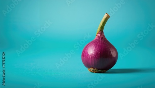 Fototapeta Naklejka Na Ścianę i Meble -  Purple onion with a green stem on a turquoise backdrop, fiber-dense choice