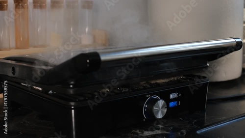 Meat frying on electric grill close-up