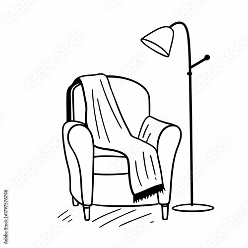 Cozy armchair with blanket and floor lamp