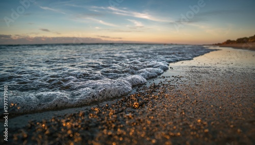 The shoreline was swept by waves bringing dark sand ashore